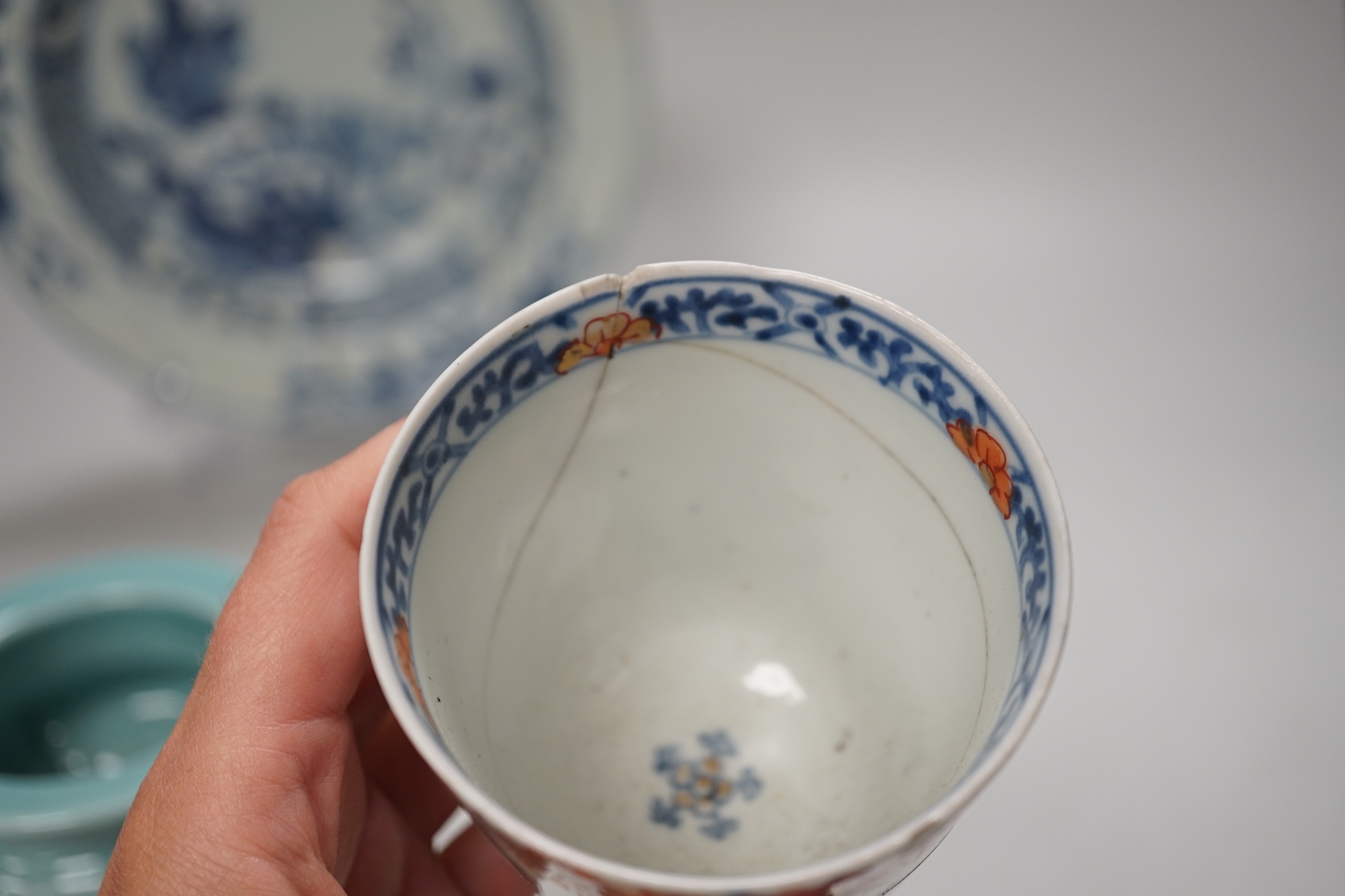 An 18th century Chinese export blue and white dish, celadon glazed tripod censer (20th century) and a Japanese Arita teacup